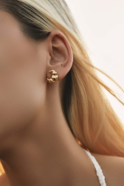 Close-up of woman wearing SUIHE Jewelry 'Croissant' stud earrings, 18k gold vermeil, showcasing elegant Parisian-inspired design.