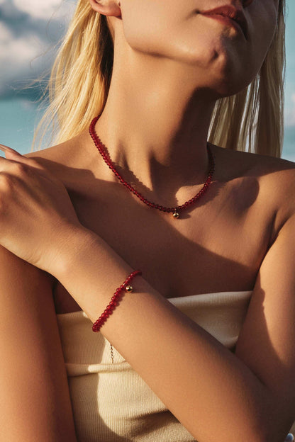 Woman wearing "Lucky" Red Agate Gemstone Bracelet and Necklace by SUIHE Jewelry, symbolizing hope, resilience, and good luck.