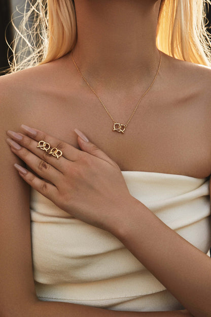 Model wearing SUIHE Jewelry "Pretzel" Stud Earrings and necklace in 18k Gold Vermeil over Sterling Silver.