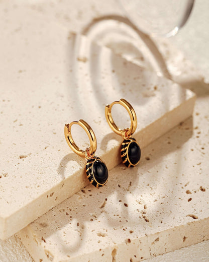 Eclipse black onyx and enamel pendant earrings by SUIHE Jewelry on gold-plated sterling silver hoops.