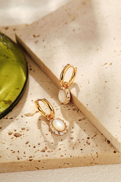 Luna mother-of-pearl pendant earrings by SUIHE Jewelry, featuring 18k gold vermeil and white enamel on a textured surface.