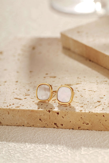 Moonlight Mother-of-Pearl Stud Earrings set in 18k Gold Vermeil by SUIHE Jewelry, featuring iridescent pearls on stone slab background.