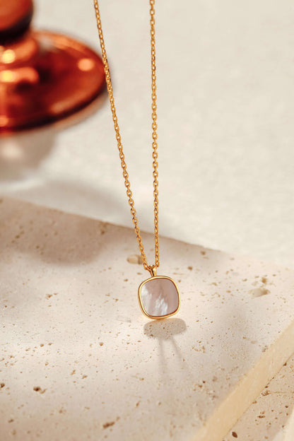 "Moonlight" Mother-of-Pearl Necklace with 18k Gold Vermeil and sterling silver by SUIHE Jewelry on a textured surface.