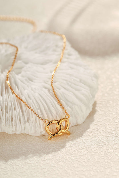SUIHE Jewelry "Pretzel" Necklace in 18k Gold Vermeil on textured surface, embodying Parisian charm and elegance.