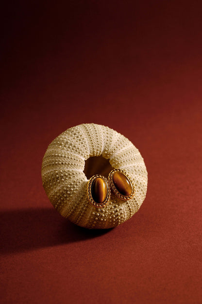 Amber earrings with Tiger's Eye stone and 18k gold vermeil from SUIHE Jewelry, displayed on a textured surface for elegance.
