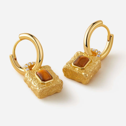 Gold-plated huggie hoop earrings with textured lock pendant featuring Tiger Eye stone by SUIHE Jewelry, symbolizing strength and style.