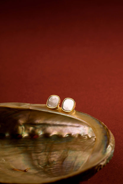 Moonlight Mother-of-Pearl Stud Earrings by SUIHE Jewelry in 18k Gold, set on an iridescent shell with a warm background.