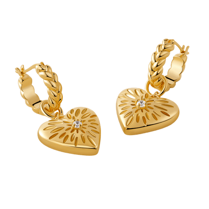 Gold-tone "Amour" pendant earrings by SUIHE Jewelry featuring heart charms with starburst designs and crystal centerpieces.