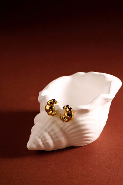 18k Gold Vermeil Croissant Stud Earrings by SUIHE Jewelry displayed on white shell against brown background.