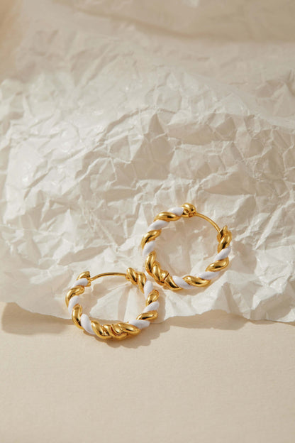 SUIHE Jewelry Dough Twist Hoop Earrings with gold and white enamel design on textured background