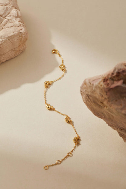 SUIHE Jewelry Croissant Mini Charm Bracelet with gold-plated chain and croissant charms, showcasing French elegance and versatility.