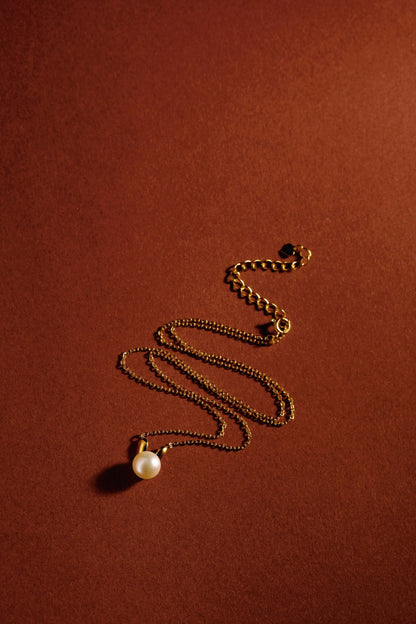 Bunny Freshwater Pearl Necklace by SUIHE Jewelry on 18k Gold Vermeil chain, elegant and playful design on textured background.