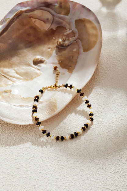 Natural Gemstone Bracelet on a seashell, featuring marbled beads, gold-tone accents, and pearls. SUIHE Jewelry elegance.