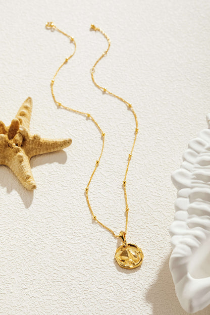 SUIHE Jewelry Pear Necklace in 18K gold with pear charm, dainty chain, and bead accents, showcasing elegance and simplicity against a soft backdrop.