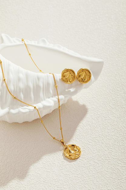 18K gold Pear necklace with bead accents from SUIHE Jewelry displayed with matching earrings on a textured surface.