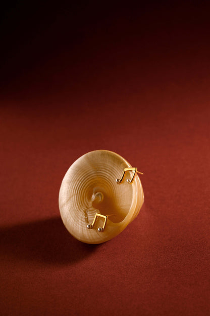 Melody Earrings by SUIHE Jewelry, 18k Gold Vermeil with freshwater pearls, showcasing delicate charm on a red background.