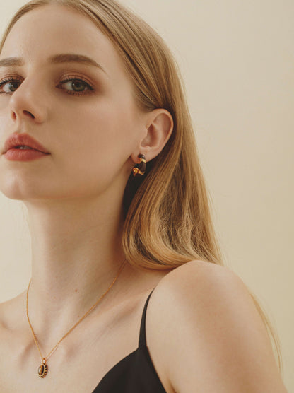 Model wearing SUIHE Jewelry "Mocha" Hoop Earrings with gold vermeil and yellow enamel, showcasing modern luxury and earthy tones.
