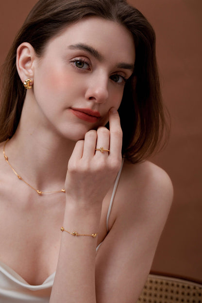 Woman wearing SUIHE Jewelry's Croissant Open Cuff Ring with matching earrings and necklace, exuding French elegance and style.