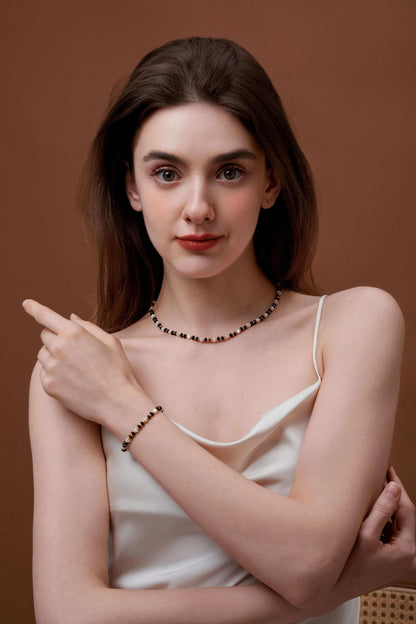 Woman wearing Marble Natural Gemstone Necklace by SUIHE Jewelry, showcasing elegance with marbled beads and pearls on a brown background.
