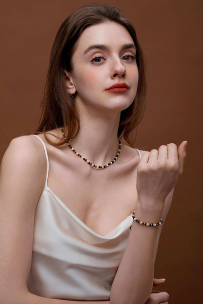 Woman wearing SUIHE Jewelry Marble Natural Gemstone Necklace with marbled beads, pearls, and gold accents, exuding elegance and style.