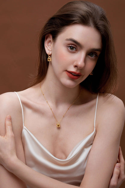 Woman wearing SUIHE Jewelry Lock Tiger Eye Stone Necklace and earrings on a gold-plated chain, showcasing elegance and style.