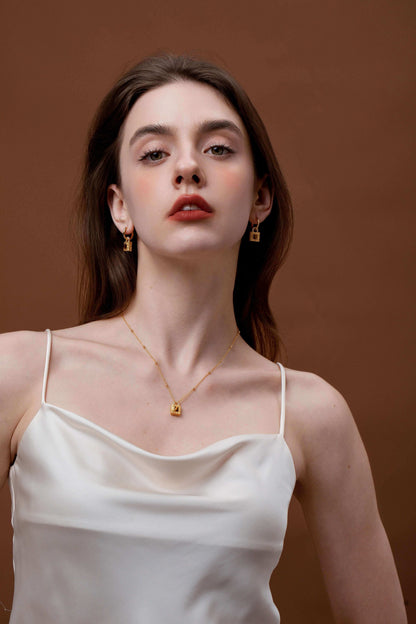 Woman wearing SUIHE Jewelry Tiger Eye Stone Necklace with gold lock pendant