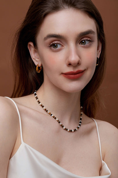 Woman wearing SUIHE Jewelry Marble Natural Gemstone Necklace with marbled beads and pearls, accentuating elegant style.