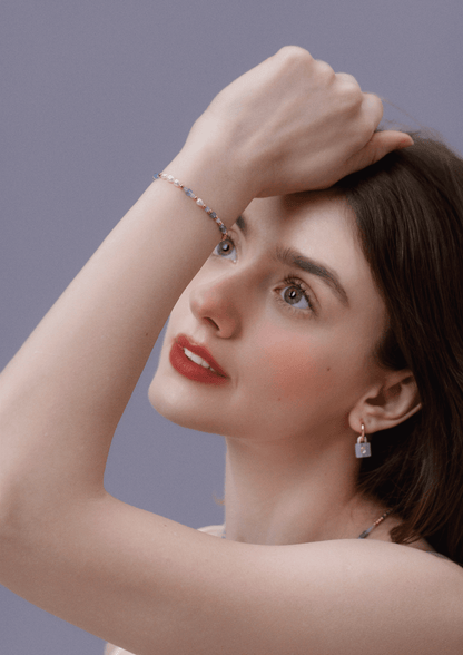 Model wearing 'Ocean' Natural Gemstone Bracelet by SUIHE Jewelry with serene blue, lavender, and white gemstones.