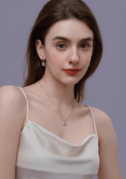 Woman wearing SUIHE Jewelry aquamarine stone necklace with gold-plated chain and lock pendant, highlighting elegance and tranquility.