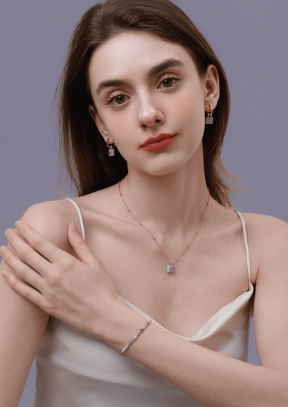 Model wearing SUIHE Jewelry aquamarine stone necklace with gold-plated chain, matching earrings, and bracelet in elegant apparel.
