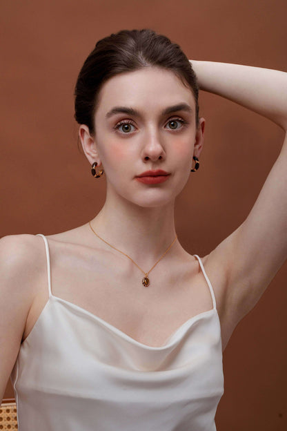 Model wearing a "Mocha" Tiger Eye Stone Necklace with gold vermeil chain by SUIHE Jewelry, showcasing cozy warmth and sophistication.
