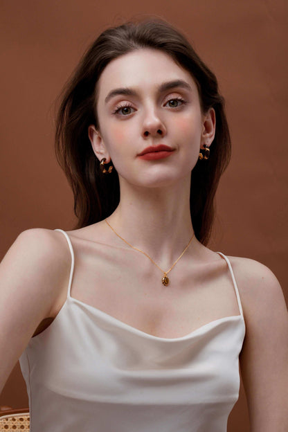 Woman wearing SUIHE Jewelry "Mocha" Tiger Eye Stone Necklace with gold vermeil chain and enamel, conveying cozy sophistication.