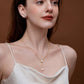 Woman wearing SUIHE Jewelry Allure Mother-Of-Pearl with Pearl Drop Necklace featuring elegant modern design on a silky white dress.