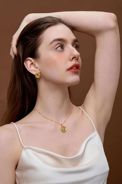 Woman wearing gold "Pear" necklace and earrings from SUIHE Jewelry, showcasing elegance and sophistication.