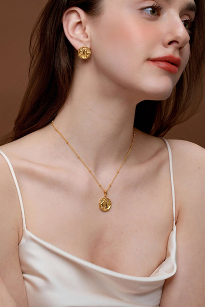 Woman wearing SUIHE Jewelry gold pear necklace and earrings set, showcasing elegance and simplicity with intricate detailing.