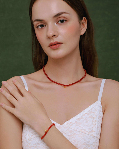 Model wearing SUIHE Jewelry's Lucky Red Agate Gemstone Bracelet and Necklace, showcasing elegance and luck with 18k gold vermeil.