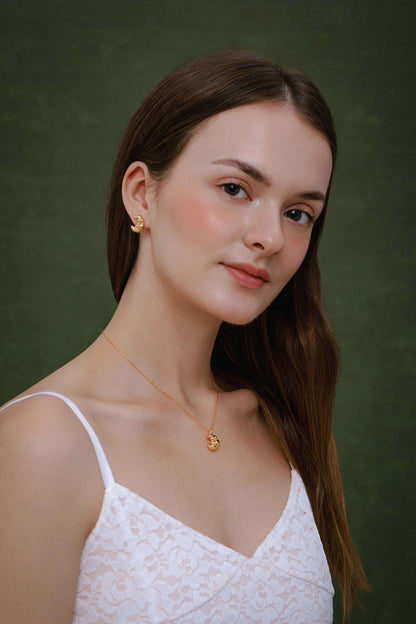 Woman wearing SUIHE Jewelry Croissant Necklace in 18k Gold Vermeil over sterling silver, evoking Parisian elegance and warmth.