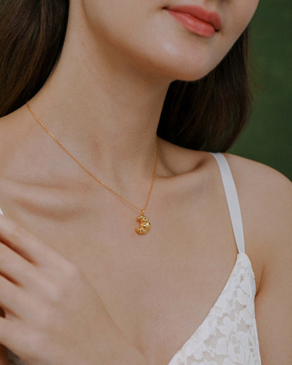 Woman wearing 'Croissant' Necklace in 18k Gold Vermeil by SUIHE Jewelry, showcasing elegant design inspired by Parisian charm.