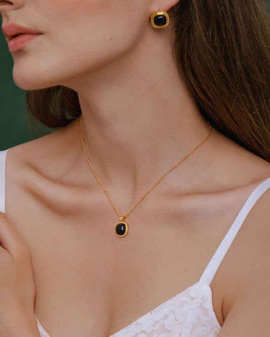 Woman wearing SUIHE Jewelry "Nocturne" Black Onyx Square Necklace, showcasing elegance and strength with 18k Gold Vermeil.