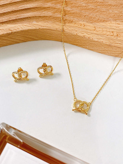 18k Gold Vermeil "Pretzel" Stud Earrings and Necklace by SUIHE Jewelry on a white surface.